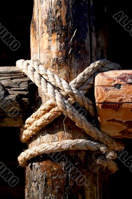 Rope, nail and wooden surface