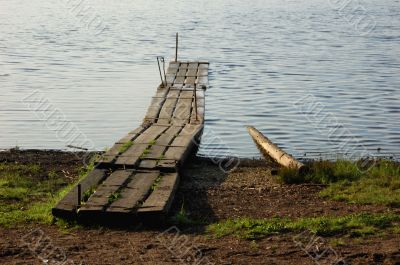 An old planked footway by the river in north Russia
