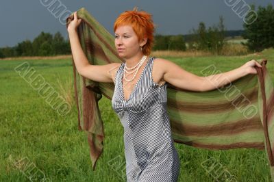 woman with scarf in a field