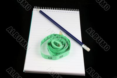 Notepad Pencil and tape measure