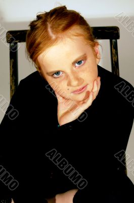 young girl sitting on a chair