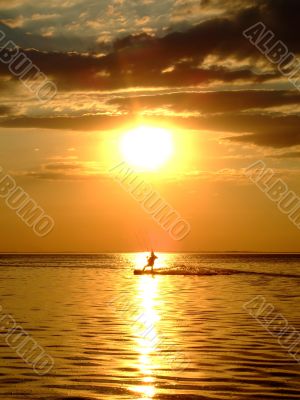 Silhouette of a kitesurf on a gulf on a sunset