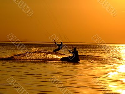 Silhouette of a two kitesurf on a gulf