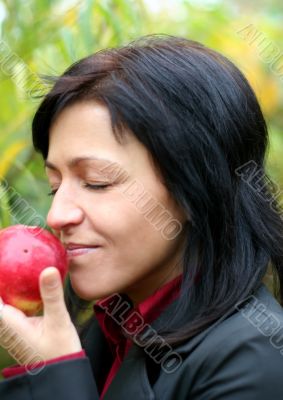 woman and apple in autumn park