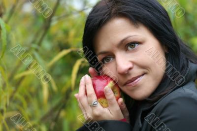 woman and apple in autumn park
