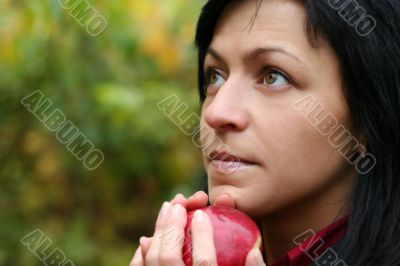 woman and apple in autumn park
