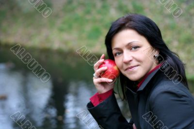 woman and apple in autumn park