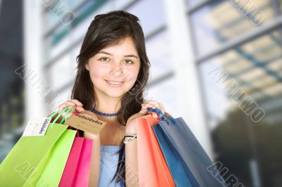 beautiful teenager with shopping bags