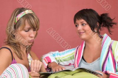 Two friends reading together