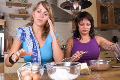 Two girl baking in the kitchen