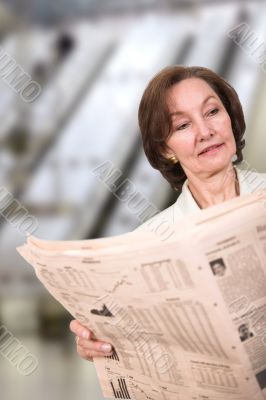 business woman reading a newspaper