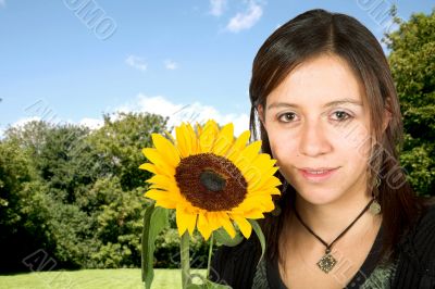 girl outdoors with a sunflower