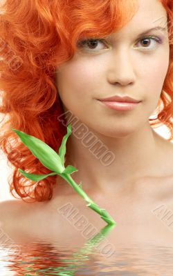 lovely redhead with bamboo in water