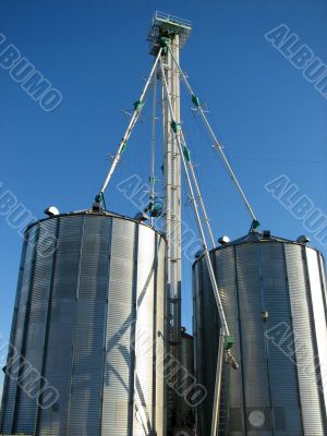 Steel grain bins and blue sky