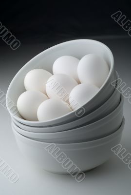 Eggs in stacked white bowls