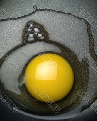 Raw egg in a frying pan