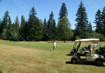 Woman golfers and carts