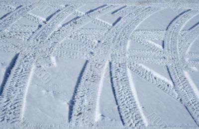 Tire tracks crossing the snowy terrain