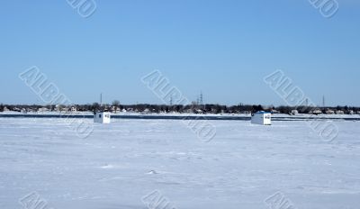 Ice fishing huts on a frozen river