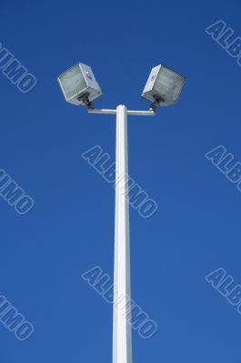 Stadium spotlights and the blue sky