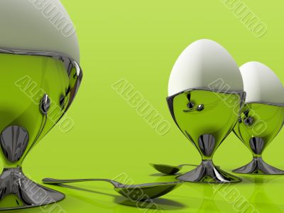 Three eggs and one metallic spoo isolated on green background