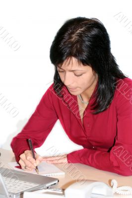 woman in office is writing