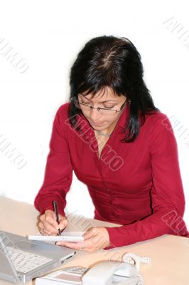woman in office is writing