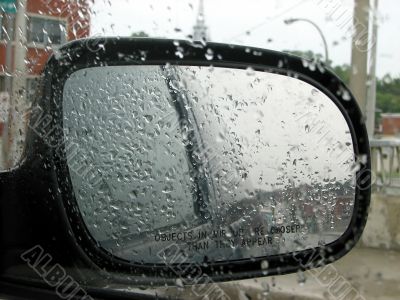 Car rear mirror with raindrops