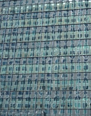 Green reflections in the windows of a skyscraper