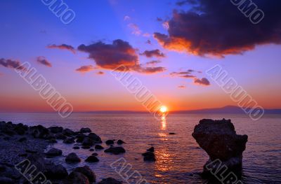 Sunset over rocky beach