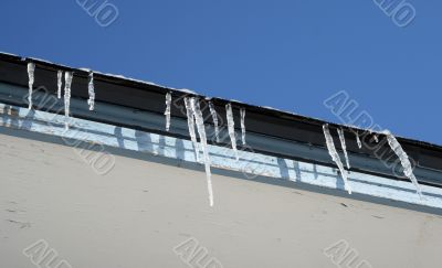 Bright winter day, icicles on the roof