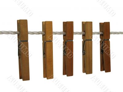 Wooden clothespins on a clothes line (+ clipping path)