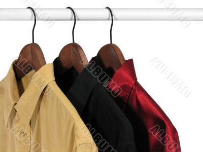 Colorful shirts on hangers, on white background