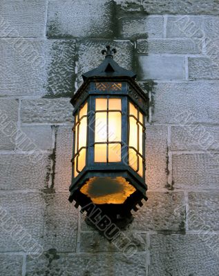 Vintage lantern on a stone wall of an old building