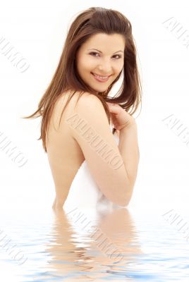 lovely brunette with white towel in water
