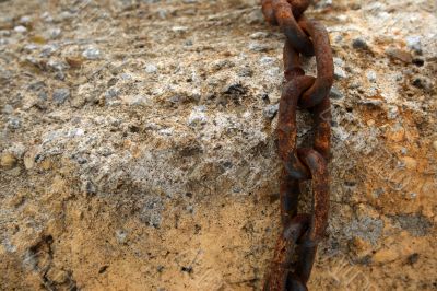 Rusty chain on a stone