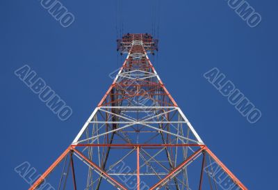 Red triangular power tower in the blue sky