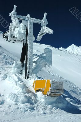 Ski lift must after snow fall in mountains.