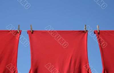 Red t-shirts on a clothes-line