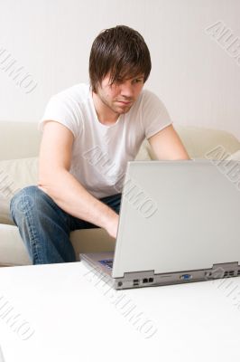 young man home with laptop