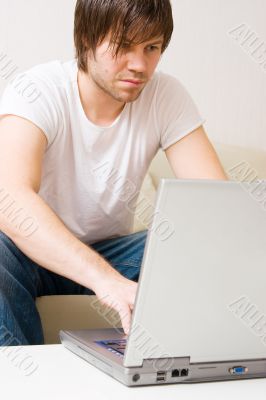 young man home with laptop