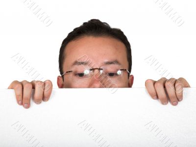 man with glasses peeping over white card