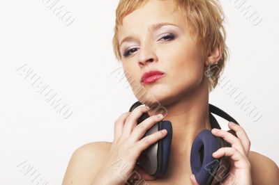 Close up portrait of young and attractive party girl with headph