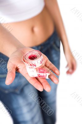hand holding tape measure - weight loss
