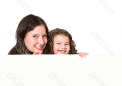 mother and daughter holding a card