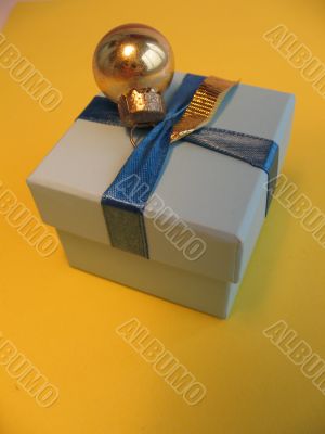 Blue gift box with one golden ball