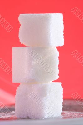 3 sugar cubes on pink