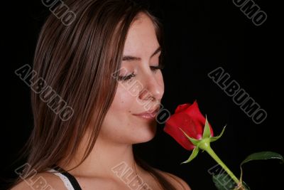 Woman smelling a red rose