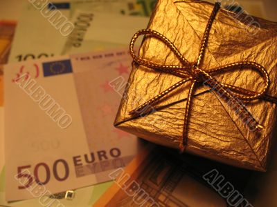 Golden christmas gift box and money