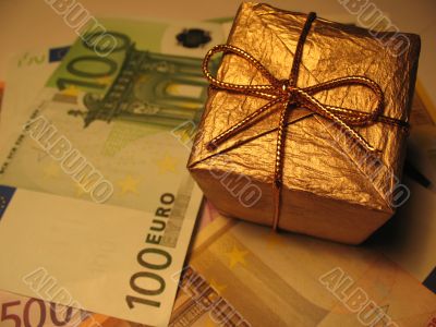 Golden christmas gift box and money